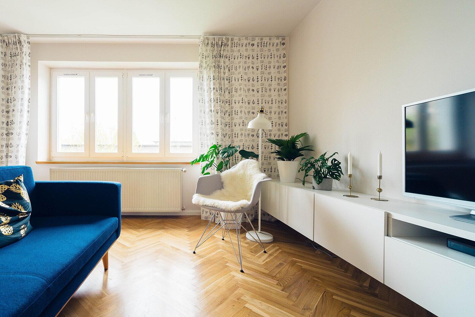 A bright living room with crisp white walls and oak parquet floors